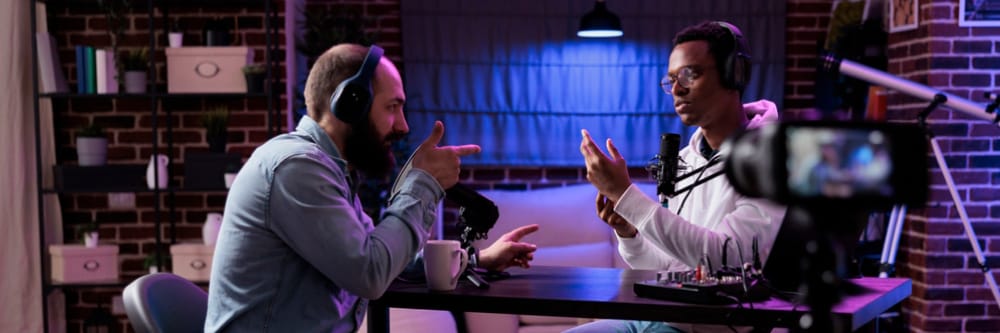Two men conversing at a table.