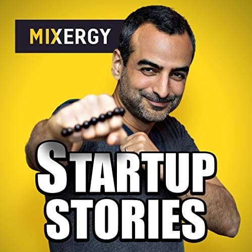 A man holding a bead while discussing on podcasts for entrepreneurs.