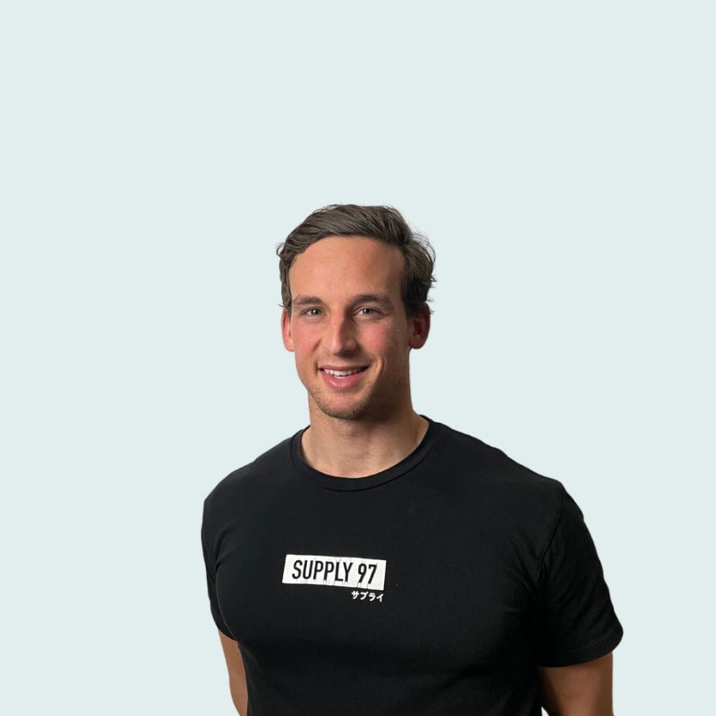 A man in a black t-shirt with "Ripletic Olympic glory" printed on it, posing against a pale background.