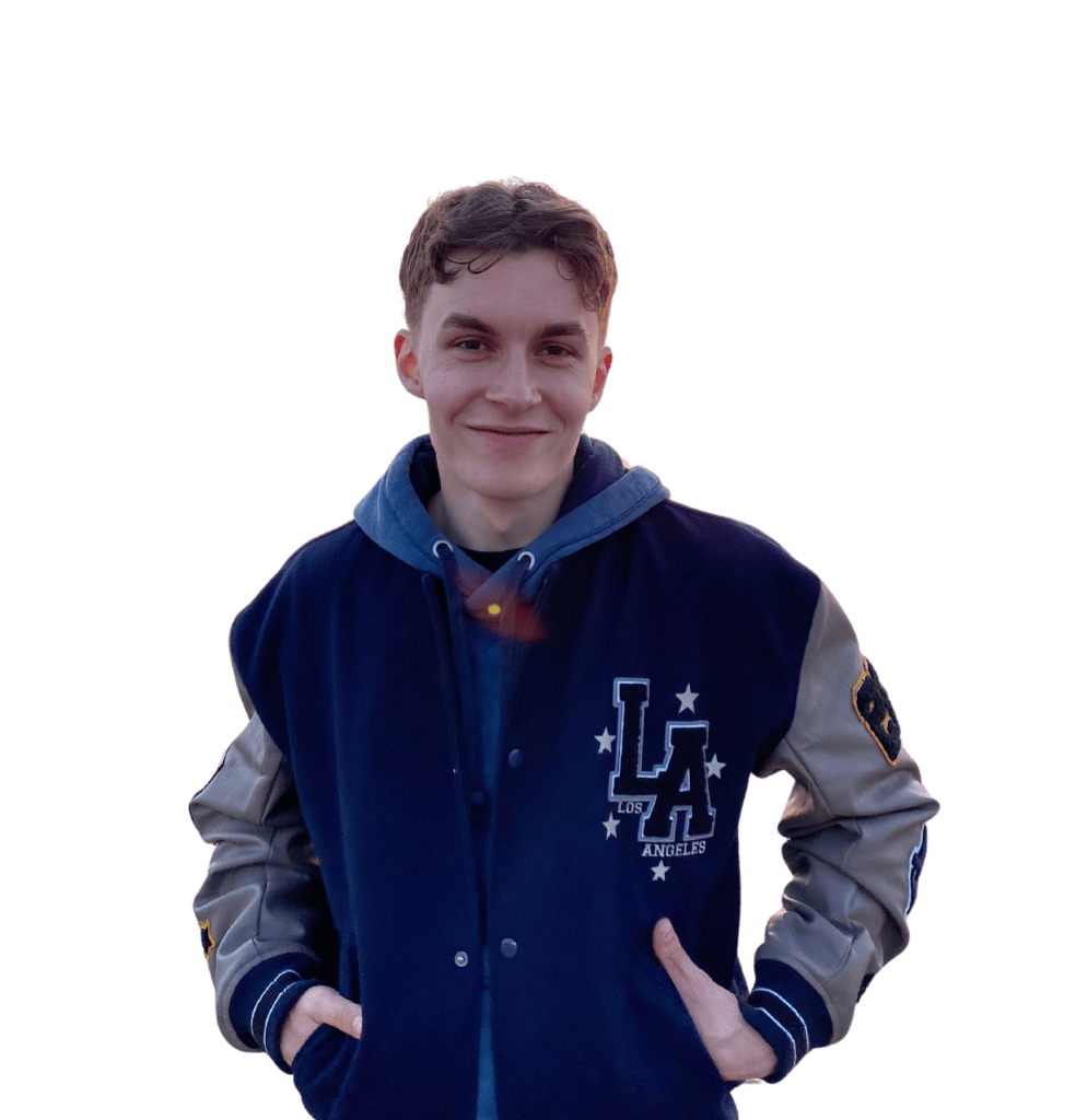 A young man smiling and wearing a blue varsity jacket with the lettering "Los Angeles" on it.