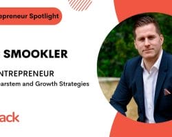 Image of a BizStack Entrepreneur Spotlight featuring Marc Smookler, a serial entrepreneur focused on building Clearstem and growth strategies. Dressed in a navy suit, he sits confidently in an outdoor setting, embodying the essence of entrepreneurial success.