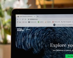 A laptop screen displays a browser with the Skillshare website open, showcasing options to explore classes and get started for free. Various browser tabs and icons are visible at the top of the screen, suggesting an honest review in progress.